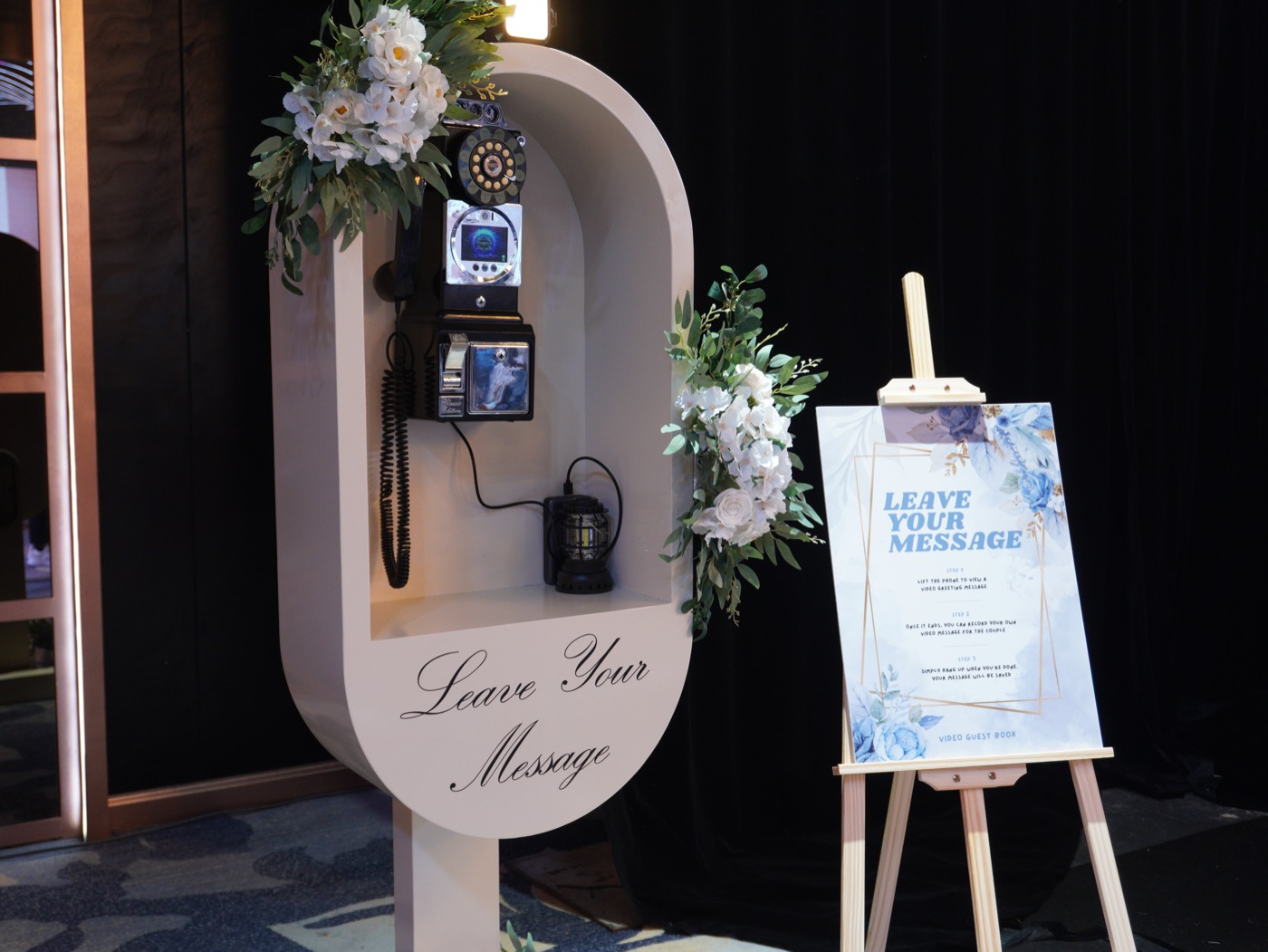 ShutterPop video guest book set up at a Malaysian event with decorated backdrop and receiver