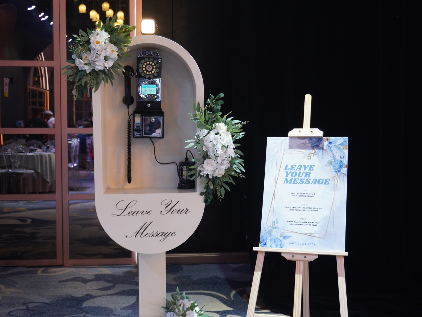 ShutterPop video guest book set up at a Malaysian event with decorated backdrop and receiver