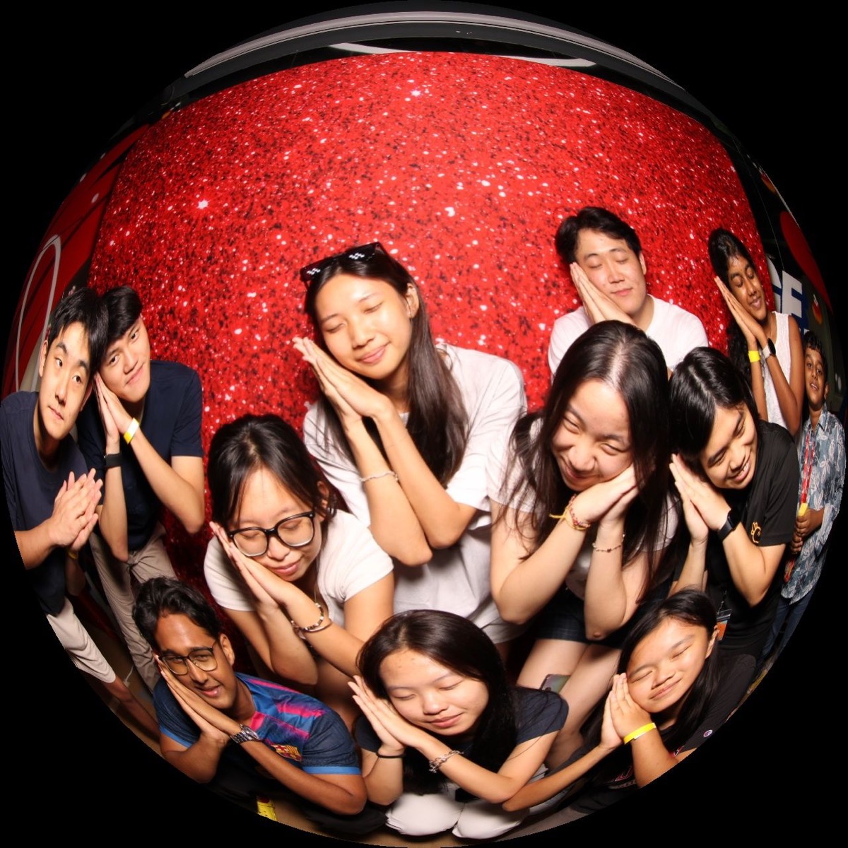 Group of guests posing in an ultra-wide fisheye photo booth shot