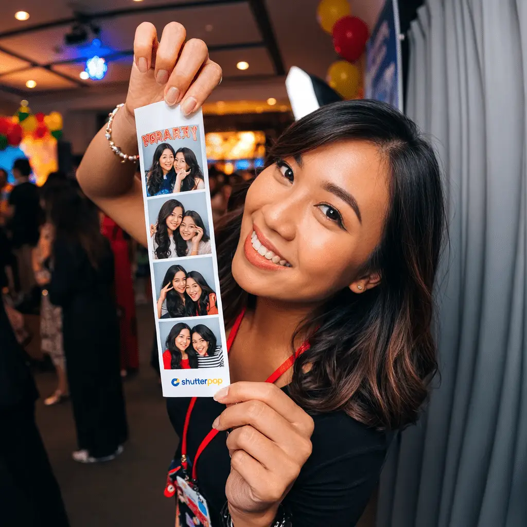 Guest holding a printed photo strip